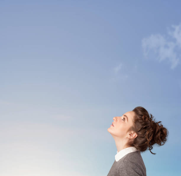 istock Girl looking at the blue sky copyspace 1124491666