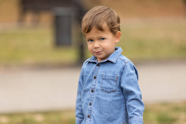 istock Beautiful young boy smiling outdoors. 1124492566