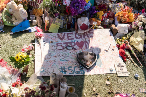Flowers, gifts candles line memorial park at the Welcome to Las Vegas sign by the Mandalay Bay on the Vegas Strip to remember the victims killed in the Las Vegas attack stock photo