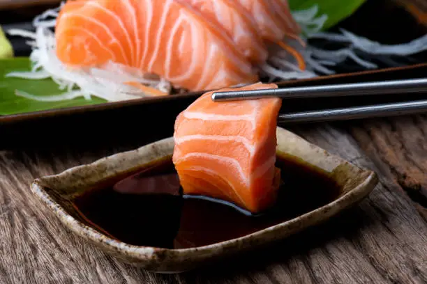 Salmon sashimi fresh and raw salmon fish slice ready to serve with shoyu sauce  in Japanese food style.