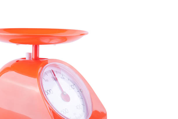 An antique brass and iron scale isolated on white. Includes a clipping path.