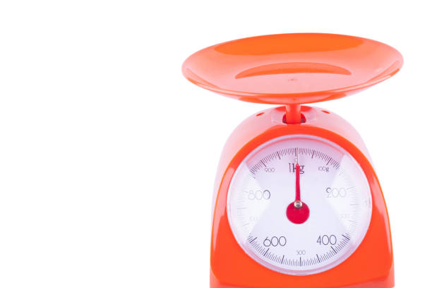 istock empty orange food scale on white background kitchen equipment object isolated 1124497219