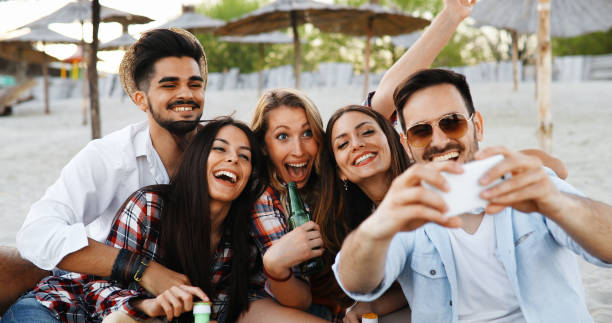 istock Happy group of young people having fun on beach 1124499445