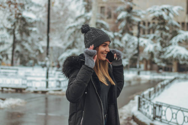 istock Cute girl talking on phone and waving 1124503745