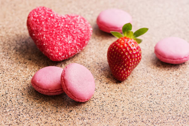 istock Pink macaroons with fresh strawberries and a red sugar heart. Valentine's Day. Selective focus. 1124505097