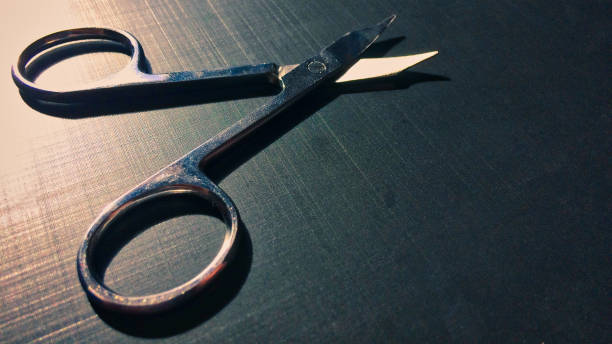 istock small nail scissors on a dark background, nail scissors, small scissors, dark background 1124505110