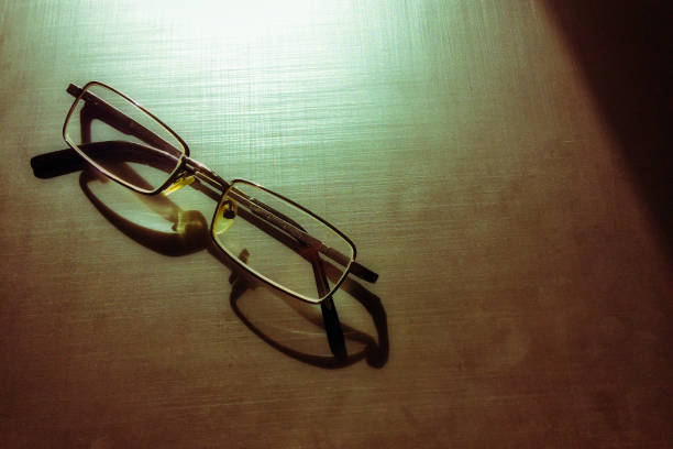 istock glasses on a dark background, shadow of the rim, metallic material 1124505843