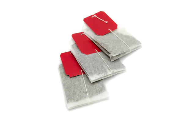 istock tea bags with red tags on white background 1124507031