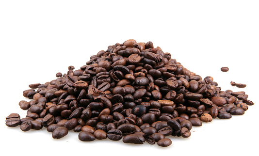 Roasted coffee beans in a 1/2 cup measure to prepare a correct amount of expresso coffee.