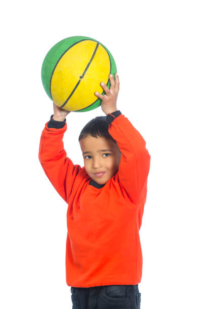 istock Happy child holding basketball 1124509529