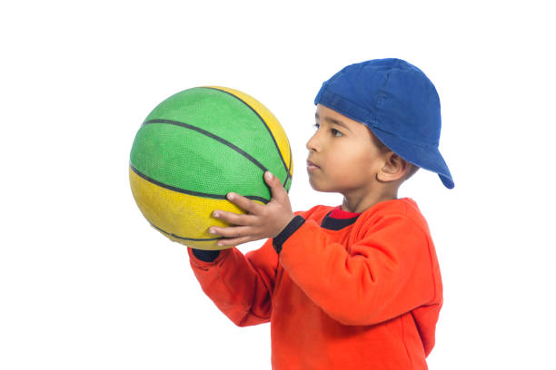 istock Happy child holding basketball 1124509743