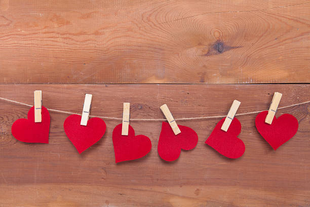 istock Tiny red heart sign isolated on wooden background. 1124510189