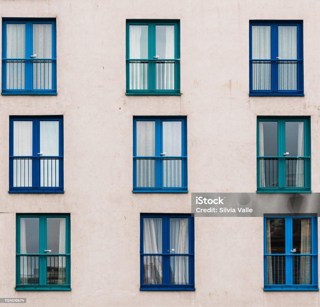 Asymmetry of windows Windows arranged asymmetrically on the facade of a building Window Stock Photo