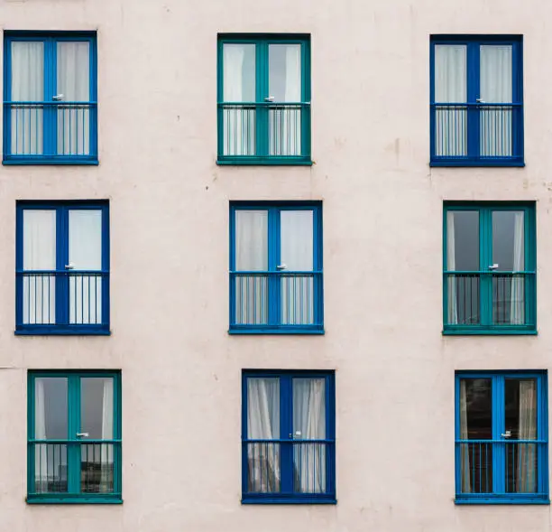 Windows arranged asymmetrically on the facade of a building