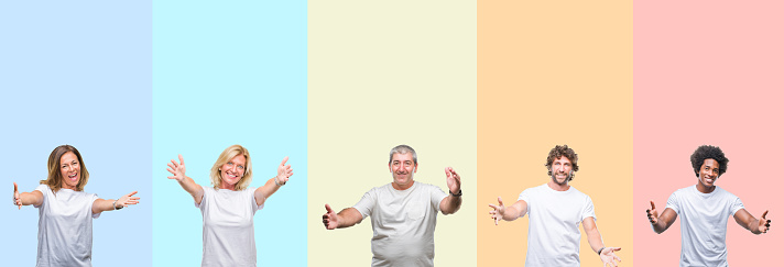 Collage of group of young and middle age people wearing white t-shirt over color isolated background looking at the camera smiling with open arms for hug. Cheerful expression embracing happiness.
