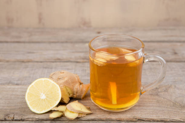 istock Ginger tea in a cup on wooden background 1124512078