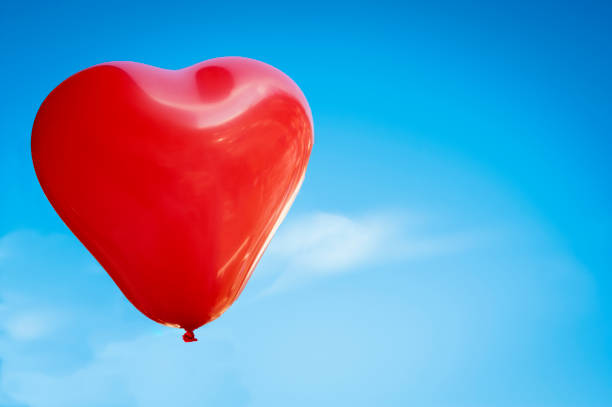 istock Red balloon on a blue sky - Valentine's day 1124512599