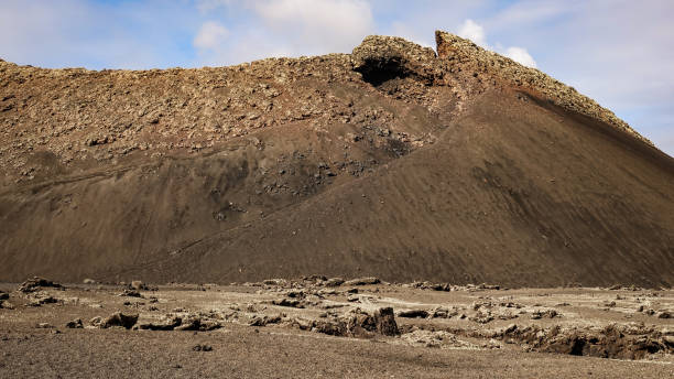 istock Volcano caldera crater with lava fields in the foreground. 1124515782