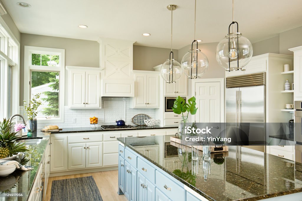 Modern Kitchen design with open concept and bar counter +++NOTE TO INSPECTOR: Photo artwork on the counter is taken by me, see property release.+++

A contemporary kitchen with open concept design and bar counter in a modern home. Kitchen Stock Photo