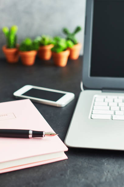 istock Bloggers desk with phone and laptop 1124519135
