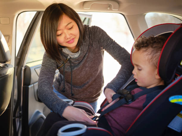 istock Woman with Child in Carseat 1124521402