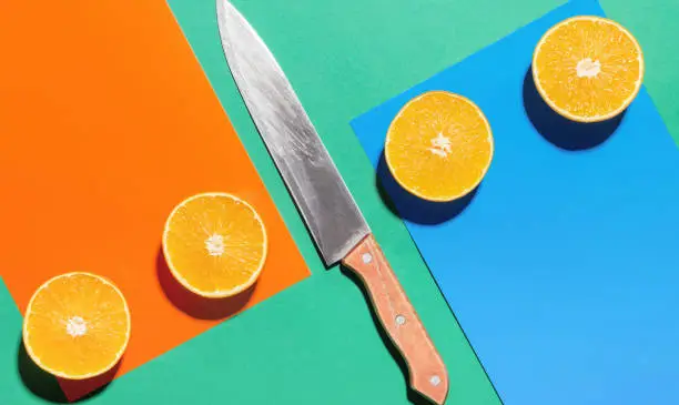 Orange fruit on a blue and orange colors background. Art concept