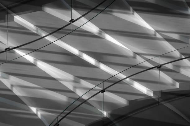 istock Computer graphic image of white staircase with glass balustrade in contrast lighting. Realistic though unreal modern or futuristic architecture fragment with multiple shadows. 1124524323