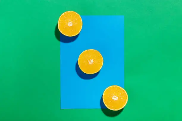 Orange fruit on a blue and green background. Art Minimal concept