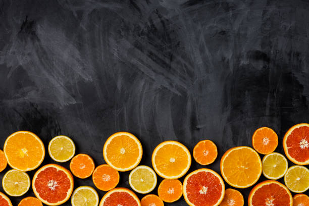 istock Frame border with citrus at dark background 1124527088