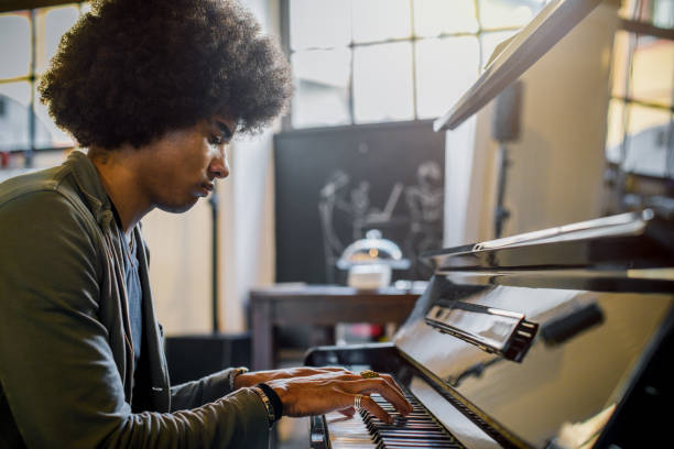 istock Afro american man playing piano at restaurant lounge 1124527261