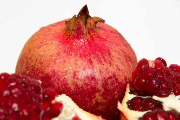 Photo of Purified pomegranate fruit on a white background
