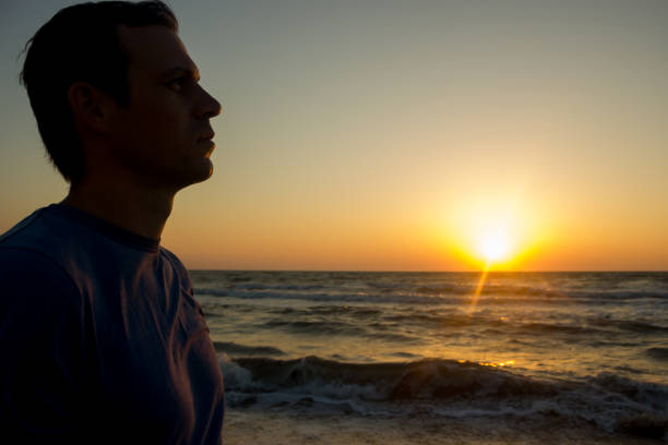 istock Portrait of a young man on the beach 1124527483