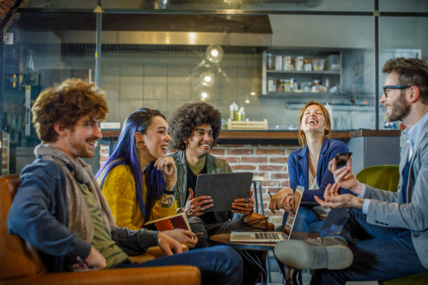istock Colleagues and clients talking strategy with laptop and tablet.Side view.Group of multiethnic people having business team meeting in restaurant lounge.Teamwork,corporate,diversity and social concepts. 1124527602