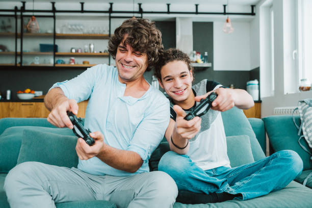 istock Father and son playing digital games at home 1124529068