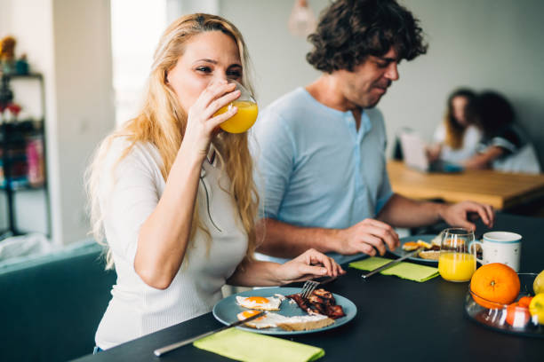 istock Happy couple enjoying breakfast together 1124529073