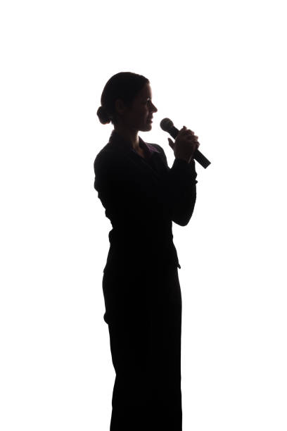 istock Young woman singing into the microphone 1124529100