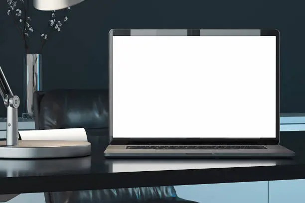 Close up of laptop with blank white screen, switched-on lamp on table. workspace. 3d rendering. Empty space.