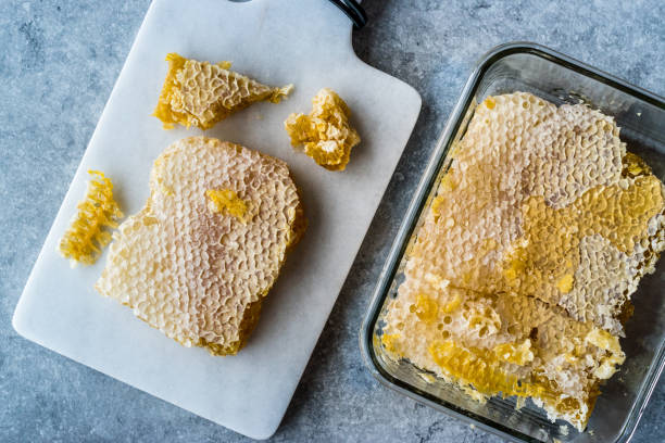 istock Fresh Honeycomb Slices with Honey on Marble Board. 1124531380