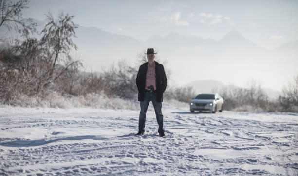 istock crime man with gun outdoors, winter 1124532322