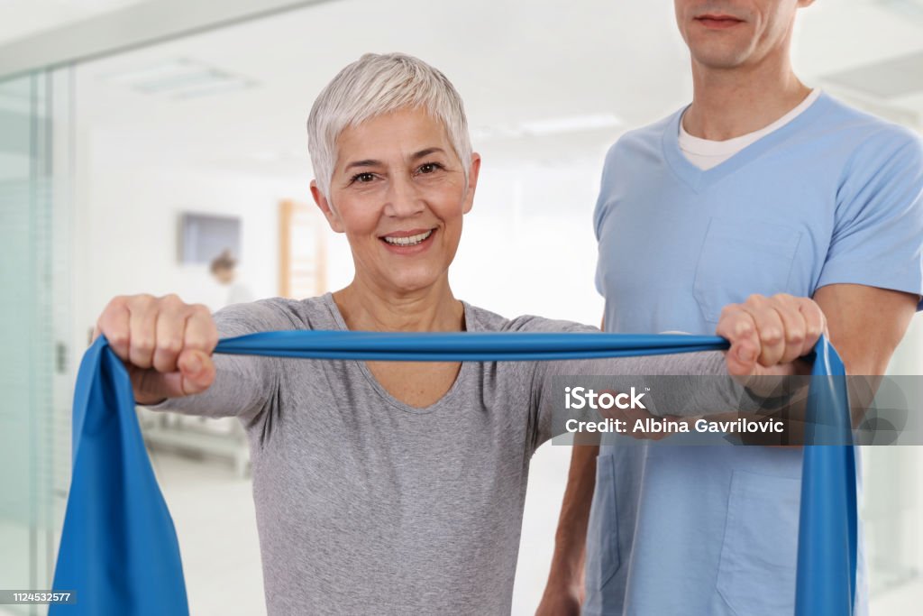 Woman having chiropractic back adjustment. Osteopathy, Physiotherapy, Physiotherapy, injury rehabilitation treatment with Resistance Band, holistic care Physical Therapy Stock Photo
