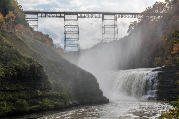 Mist Climbs Upward Towards the Portage Viaduct Water vapor from the falling waters of the Genesee River rise up towards the Portage Viaduct in New York's Letchworth State Park. letchworth garden city stock pictures, royalty-free photos & images