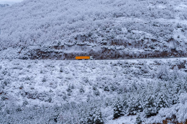 Truck on a snow covered mountain.