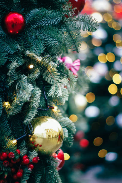 istock Fluffy fir decorated with gold and red baubles. lights 1124534601