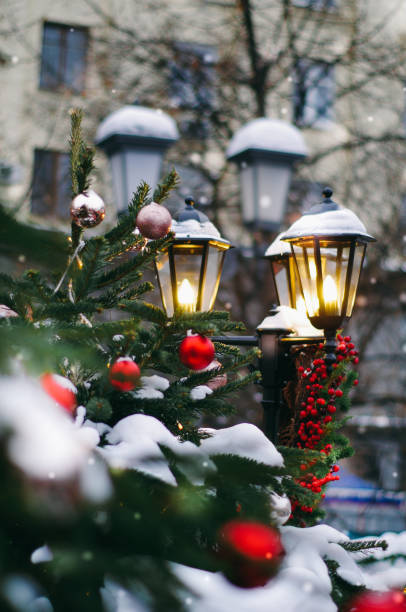 istock Street lamp decorated with christmas staff (pine cones, red berries, fir bunch) 1124534646