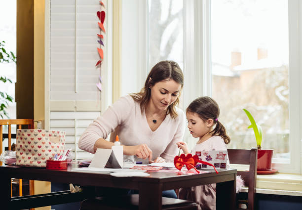 istock Mother and young daughter crafting for Valentine's Day 1124534745