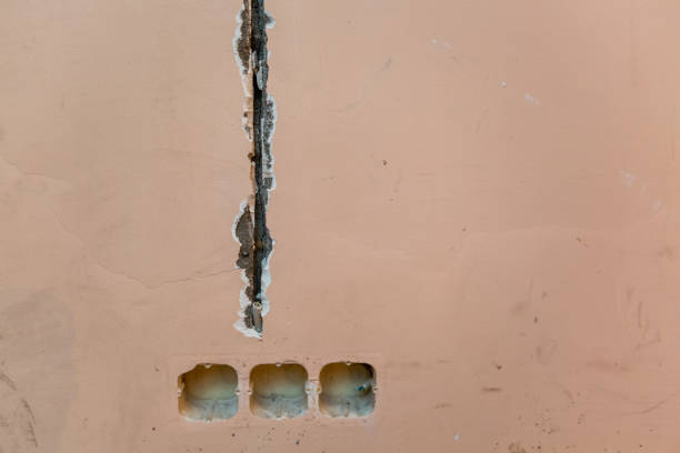 istock Working process to groove or wall chasing for electrical, internet cables and electric outlets before plastering and painting  walls  in apartment is under construction, remodeling, renovation, extension, restoration, reconstruction and home improvement 1124541074