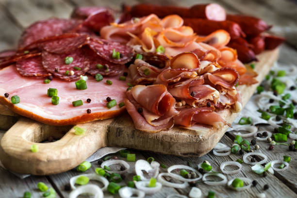 Ham, salami and sausages mix Mix of meat appetizers - salami, ham, smoked turkey, sausages and prosciutto - on rustic wooden background emilia romagna photos stock pictures, royalty-free photos & images