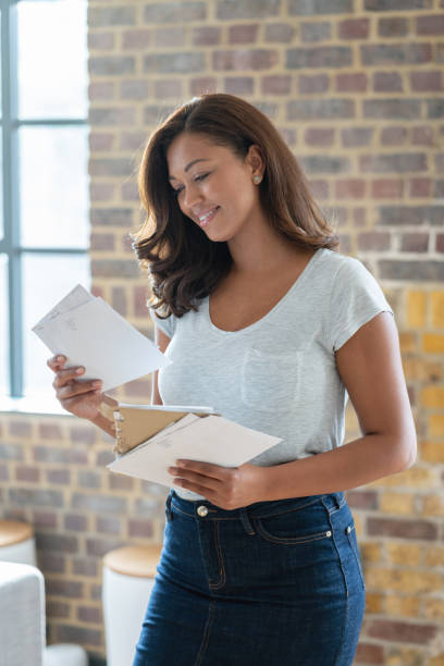 istock Beautiful woman at home checking the mail 1124546356