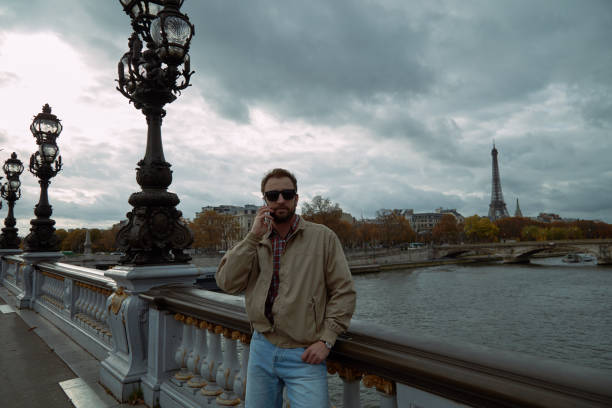 istock Modern man using cellphone in European city. 1124546935