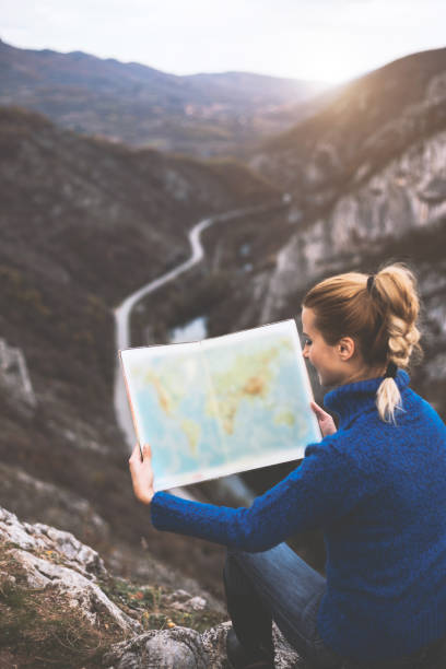 istock Happy travel woman look map 1124547460